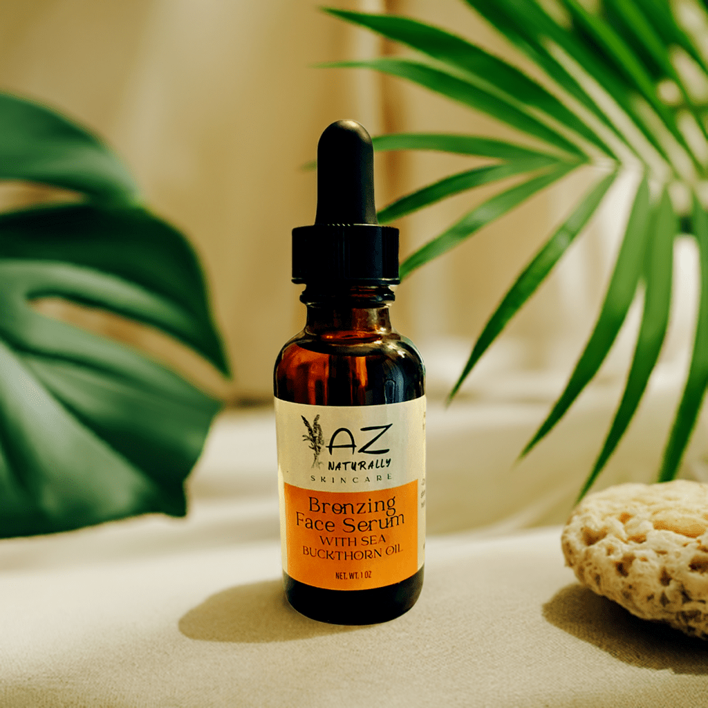 Amber dropper bottle of 'Bronzing Face Serum with Sea Buckthorn Oil' on an off-white surface with leaves in the background 