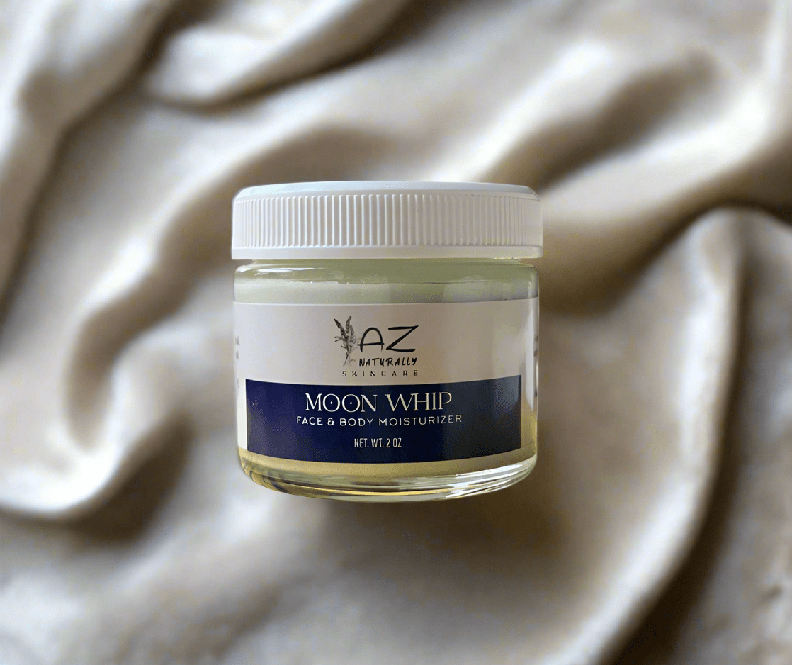 Jar of 'Moon Whip' face and body moisturizer on a silk background