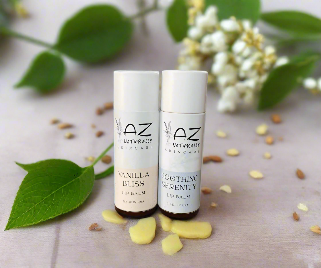 Two bottles of 'Tallow-based Lip Balm' labeled 'Vanilla Bliss' and 'Soothing Serenity' adjacent to a leaf on a light grey surface