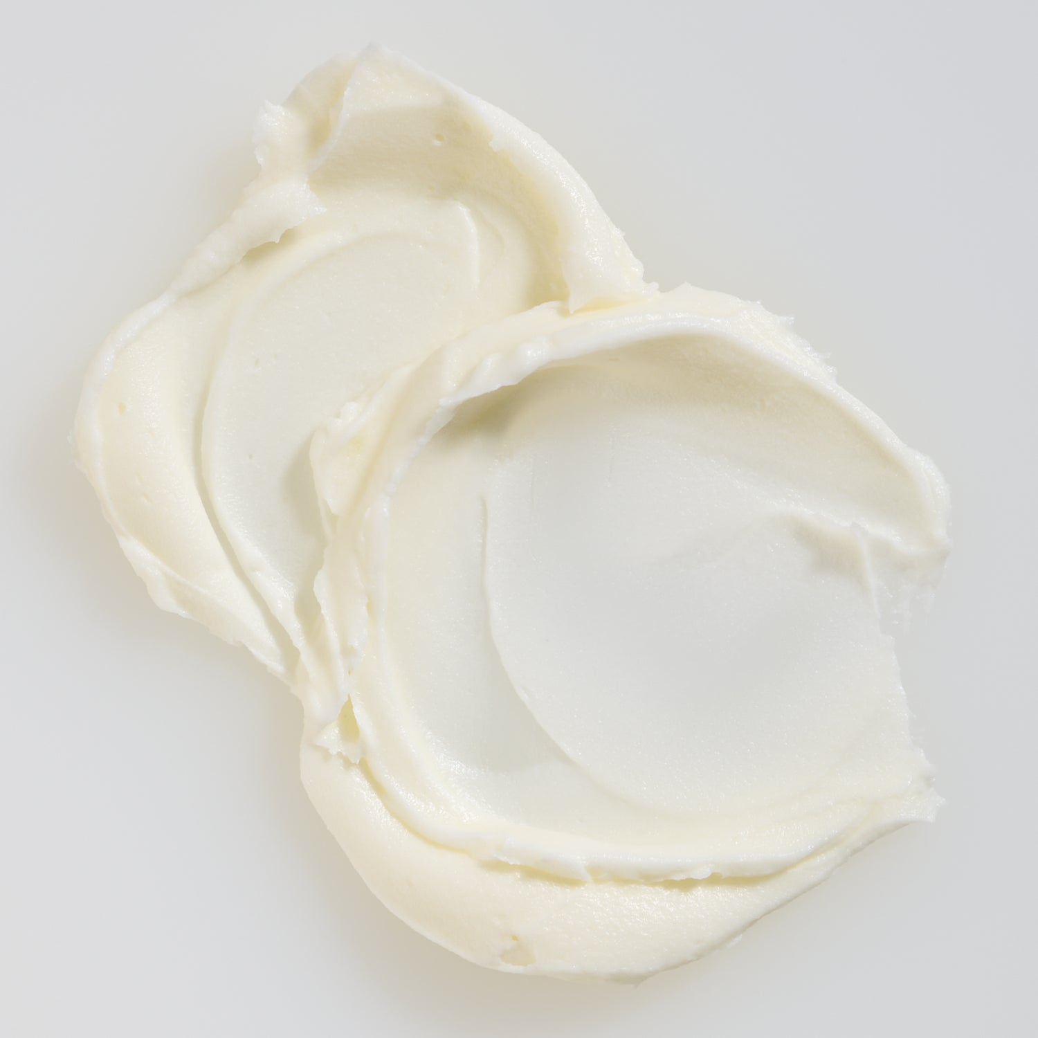 White cream contents of 'Tallow Whip Face & Body Moisturizer' on a light gray background
